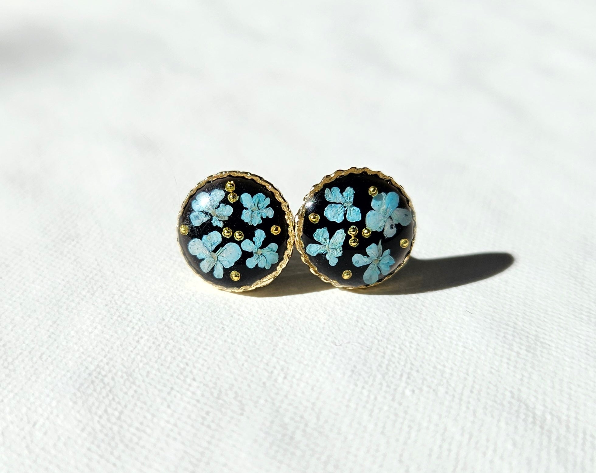 Blue lace flower in dark studs