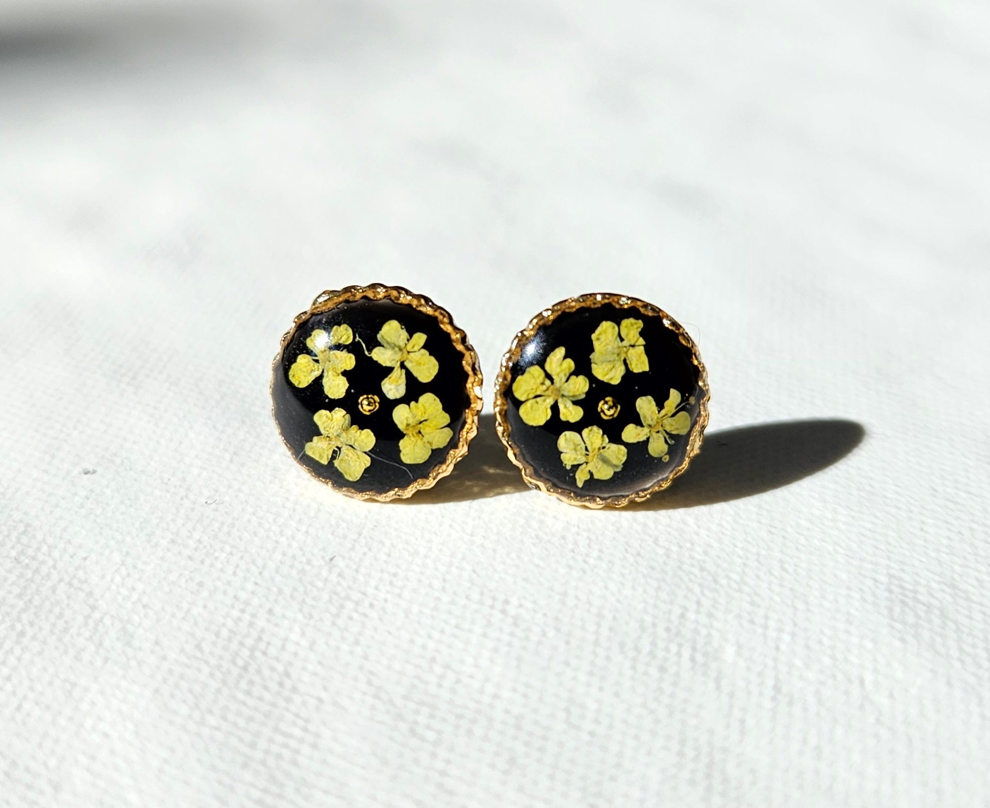 Yellow lace flower in dark studs